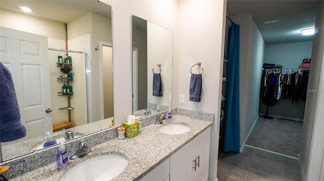 bathroom with vanity, tile patterned floors, and walk in shower