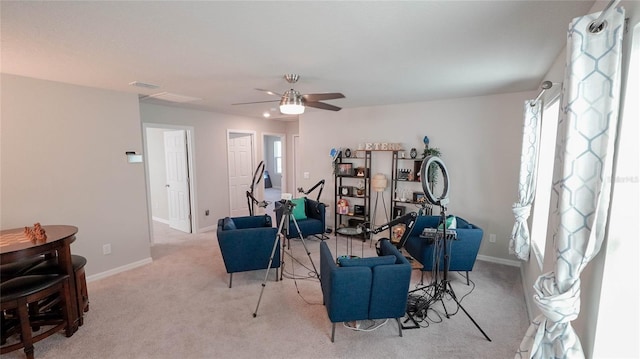 carpeted living room featuring ceiling fan