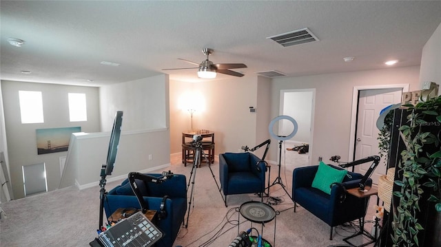 exercise room with light colored carpet and a textured ceiling