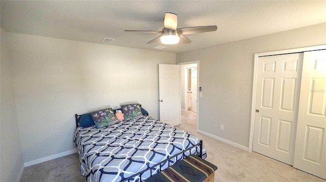 carpeted bedroom featuring a closet and ceiling fan