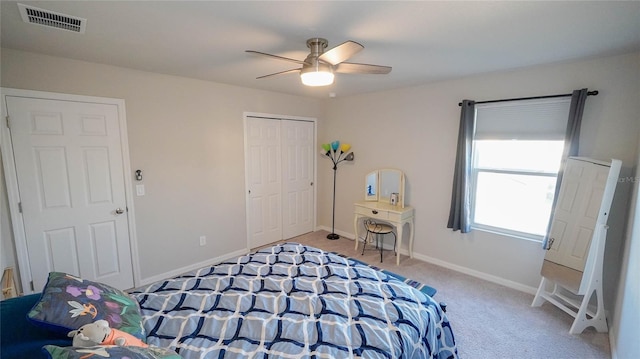 bedroom featuring light carpet, a closet, and ceiling fan