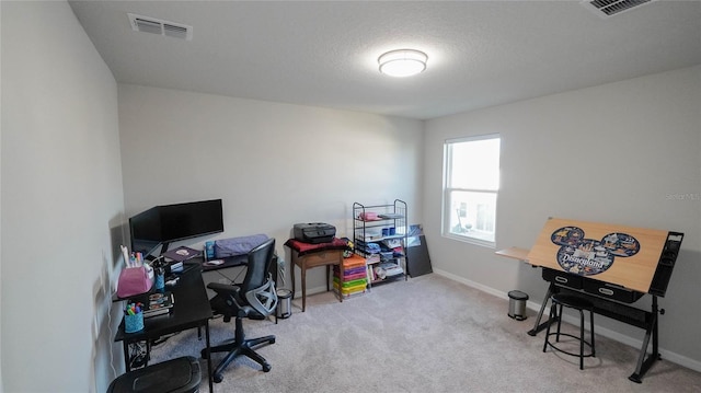 carpeted office space featuring a textured ceiling