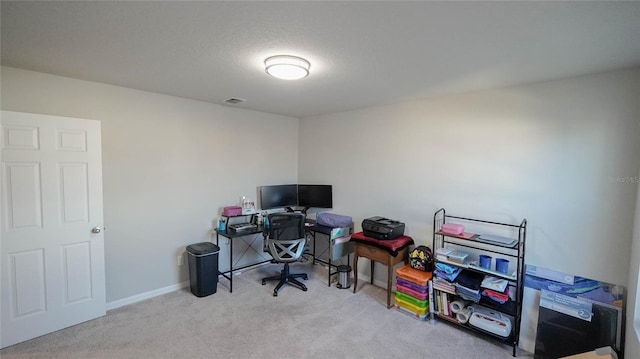 carpeted office with a textured ceiling