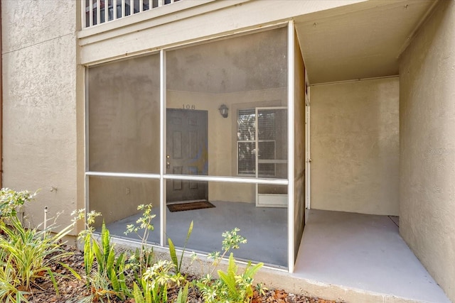 doorway to property with stucco siding