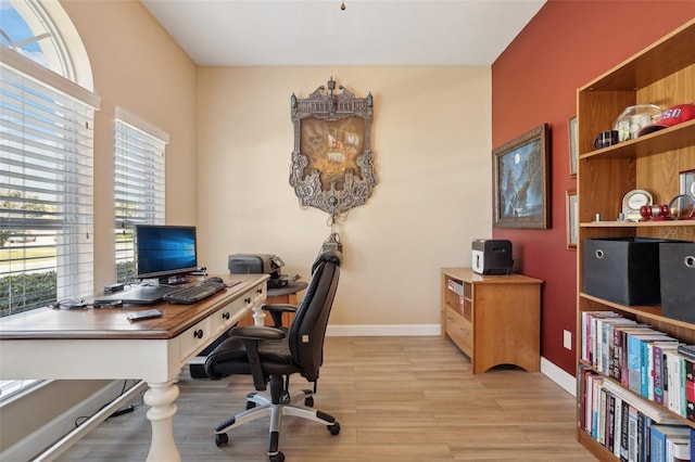 home office with light hardwood / wood-style floors