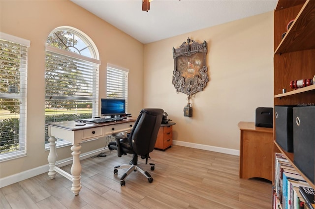 office area featuring lofted ceiling, light hardwood / wood-style floors, and ceiling fan