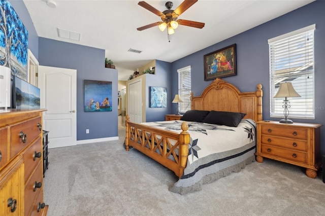 carpeted bedroom featuring ceiling fan and a closet