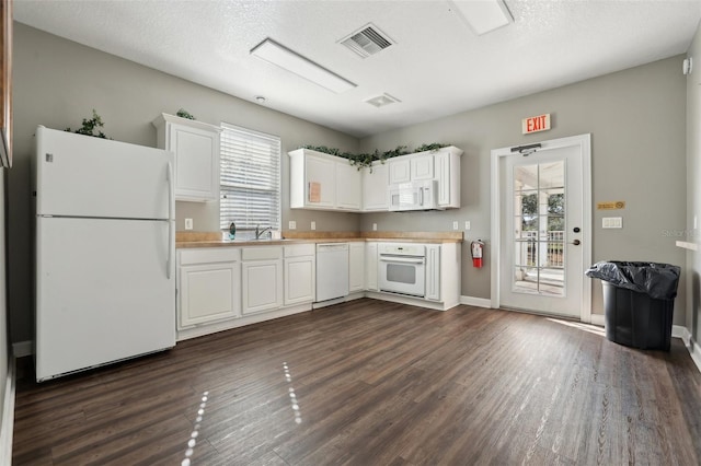 kitchen featuring white cabinetry, white appliances, and a healthy amount of sunlight