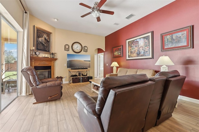 living room with ceiling fan and light hardwood / wood-style floors