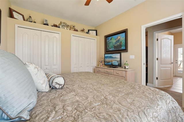 bedroom with multiple closets and ceiling fan