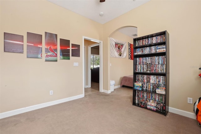 unfurnished room featuring ceiling fan and light carpet