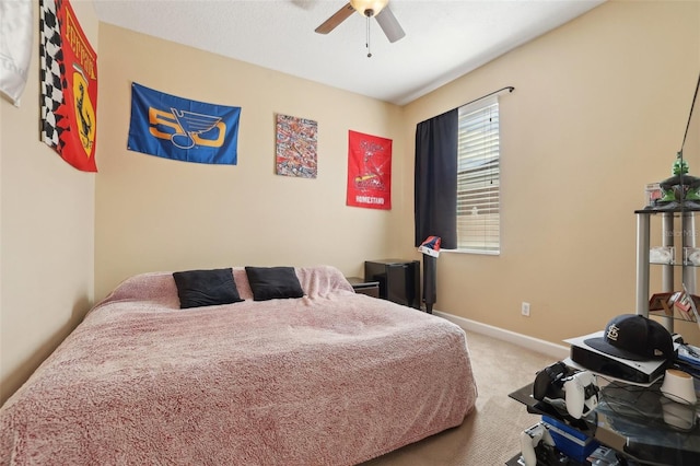 bedroom featuring ceiling fan and carpet