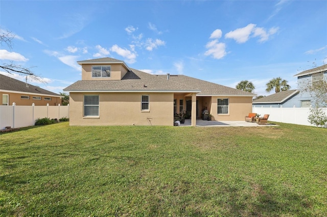 rear view of property with a lawn and a patio