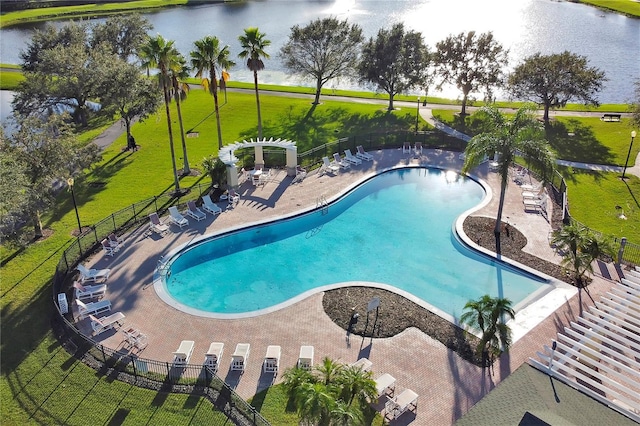 view of pool with a pergola, a patio area, and a water view