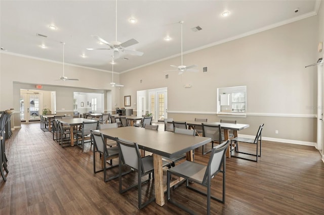 dining space with french doors, crown molding, dark hardwood / wood-style flooring, and a high ceiling