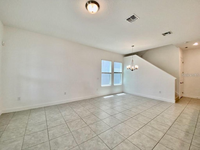 empty room with an inviting chandelier