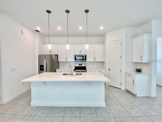 kitchen featuring pendant lighting, white cabinetry, and stainless steel appliances