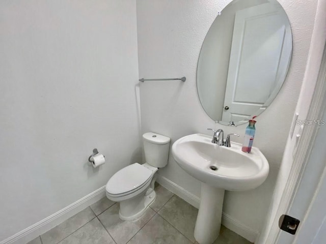 bathroom featuring tile patterned flooring and toilet