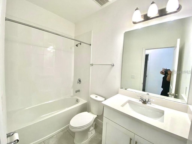 full bathroom featuring tile patterned floors, vanity, toilet, and tiled shower / bath combo