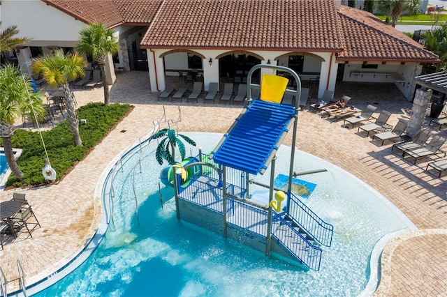 view of swimming pool with a patio