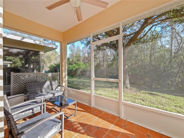 sunroom featuring ceiling fan and a healthy amount of sunlight