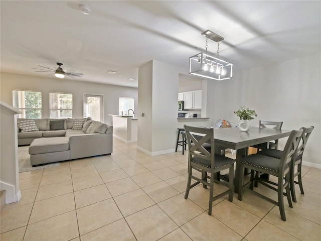 tiled dining space featuring ceiling fan