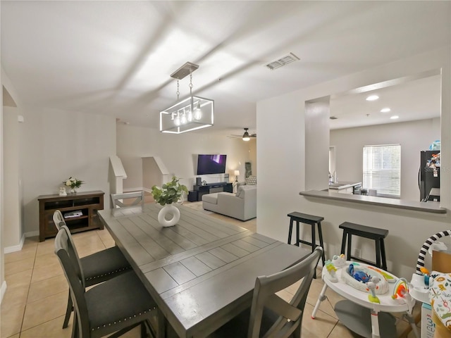 dining area featuring light tile patterned floors and ceiling fan