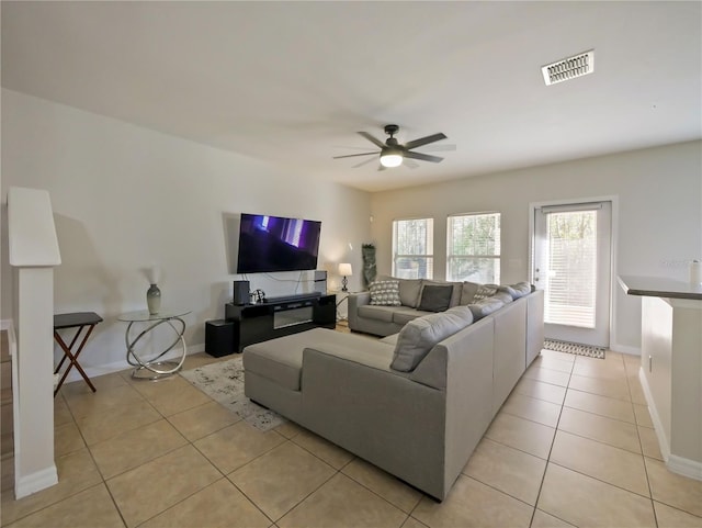 living room with light tile patterned flooring and ceiling fan