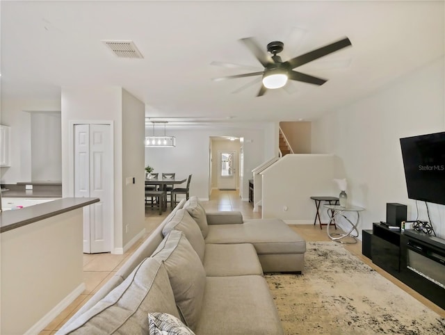 tiled living room with ceiling fan