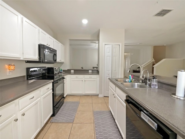 kitchen featuring white cabinetry, light tile patterned flooring, sink, and black appliances