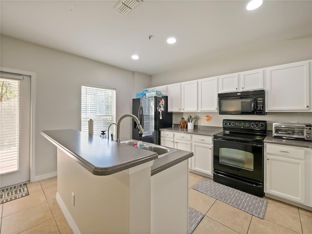 kitchen with sink, white cabinetry, black appliances, an island with sink, and light tile patterned flooring