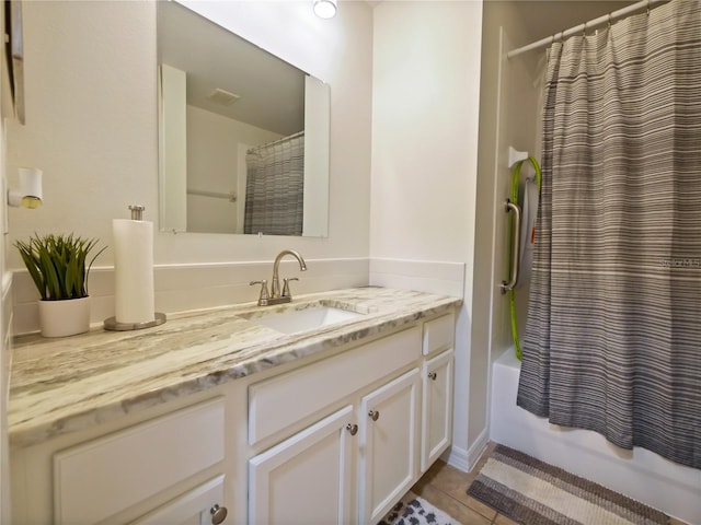 bathroom featuring vanity, shower / bath combo, and tile patterned floors