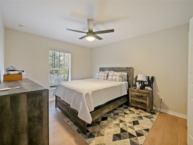 bedroom with ceiling fan and light wood-type flooring