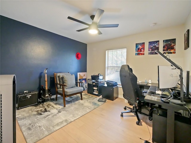 home office with hardwood / wood-style floors and ceiling fan