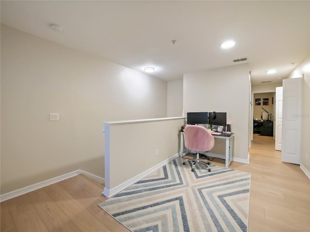 office space with light hardwood / wood-style floors