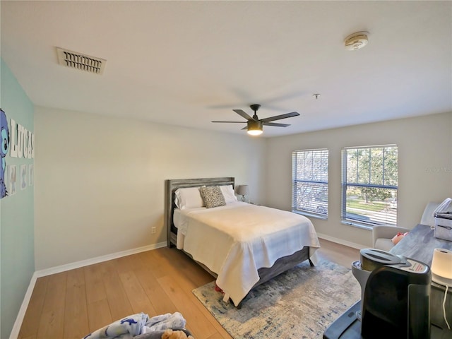 bedroom with ceiling fan and light wood-type flooring