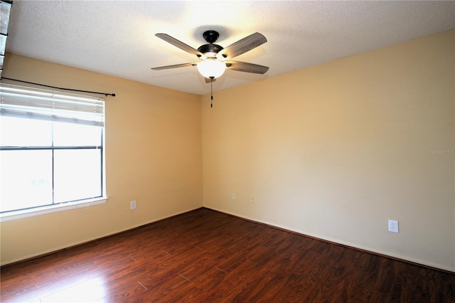 unfurnished room featuring ceiling fan, dark hardwood / wood-style flooring, and a textured ceiling