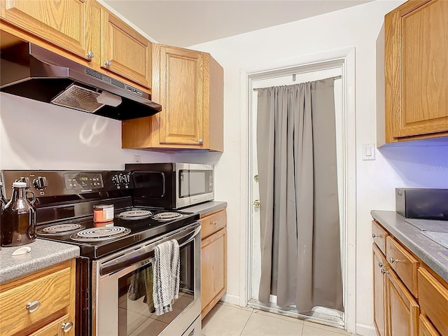 kitchen with light tile patterned floors and stainless steel appliances