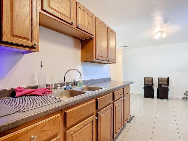 kitchen featuring sink and light tile patterned floors