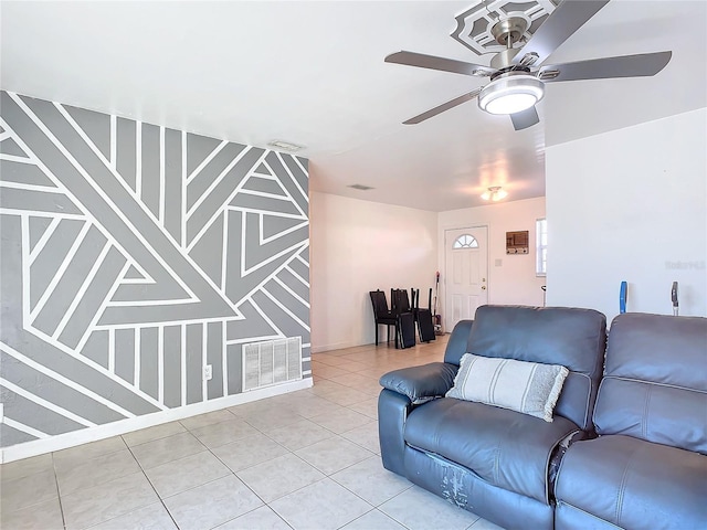 living room featuring light tile patterned flooring and ceiling fan