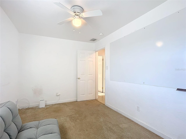 living area featuring light colored carpet and ceiling fan