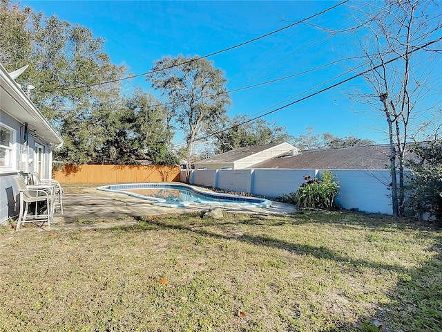 view of yard with a fenced in pool and a patio