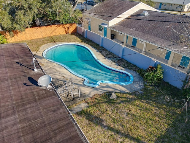 view of pool with a yard and a patio