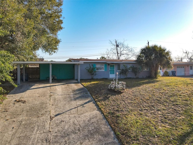 ranch-style house featuring a carport and a front yard