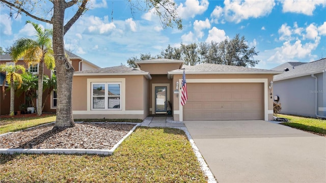 view of front of property with a garage and a front yard