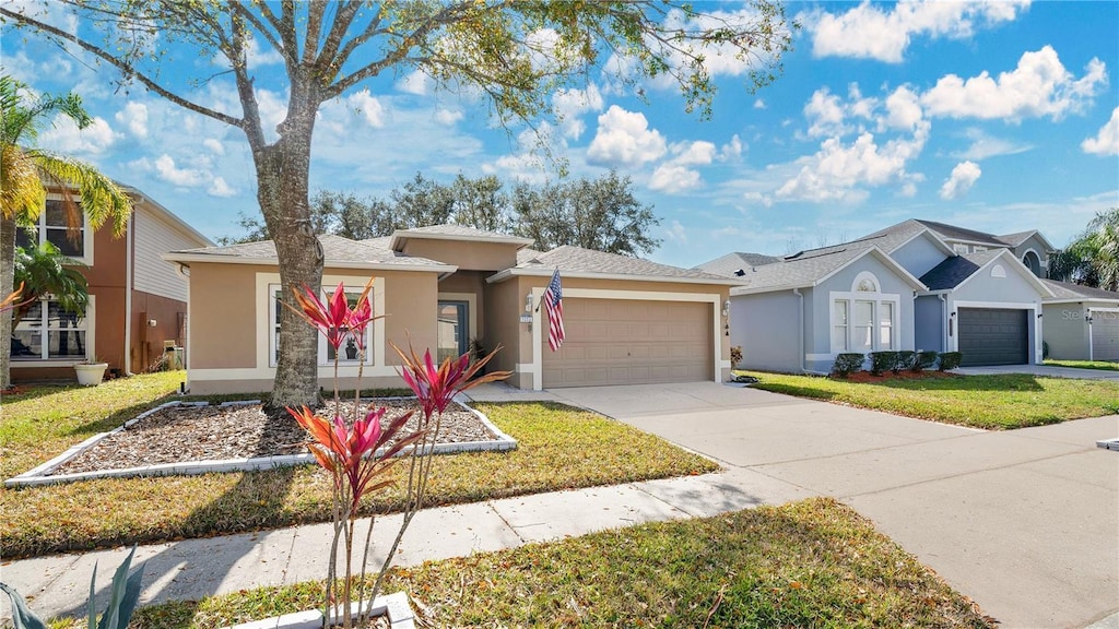 single story home with a garage and a front yard