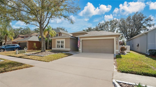 single story home featuring a garage and a front yard