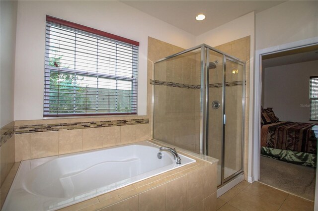 ensuite bathroom featuring a stall shower, ensuite bath, a garden tub, and tile patterned flooring