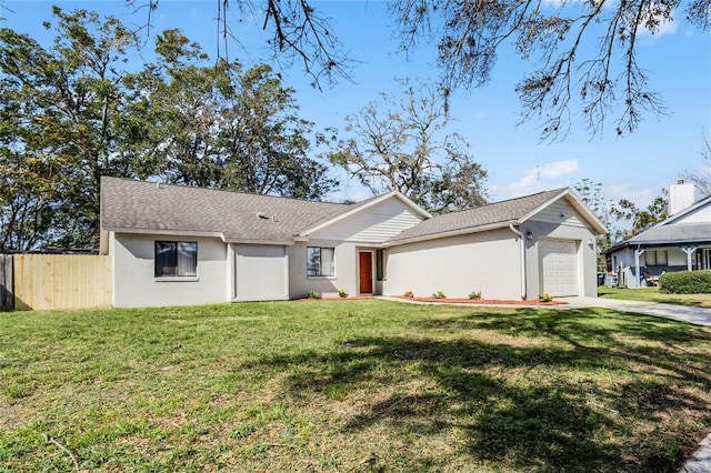 ranch-style home with a garage and a front lawn