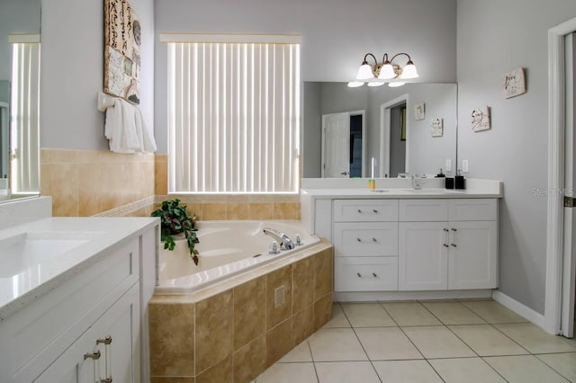 bathroom featuring tile patterned floors, tiled bath, and vanity